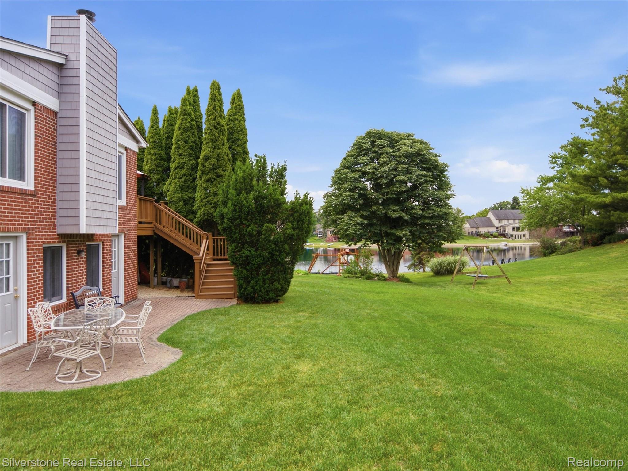 6577 Edith Court Troy, MI 48085 - Photo 54 of 61 Expansive backyard featuring a lush lawn, a paver patio, and mature trees