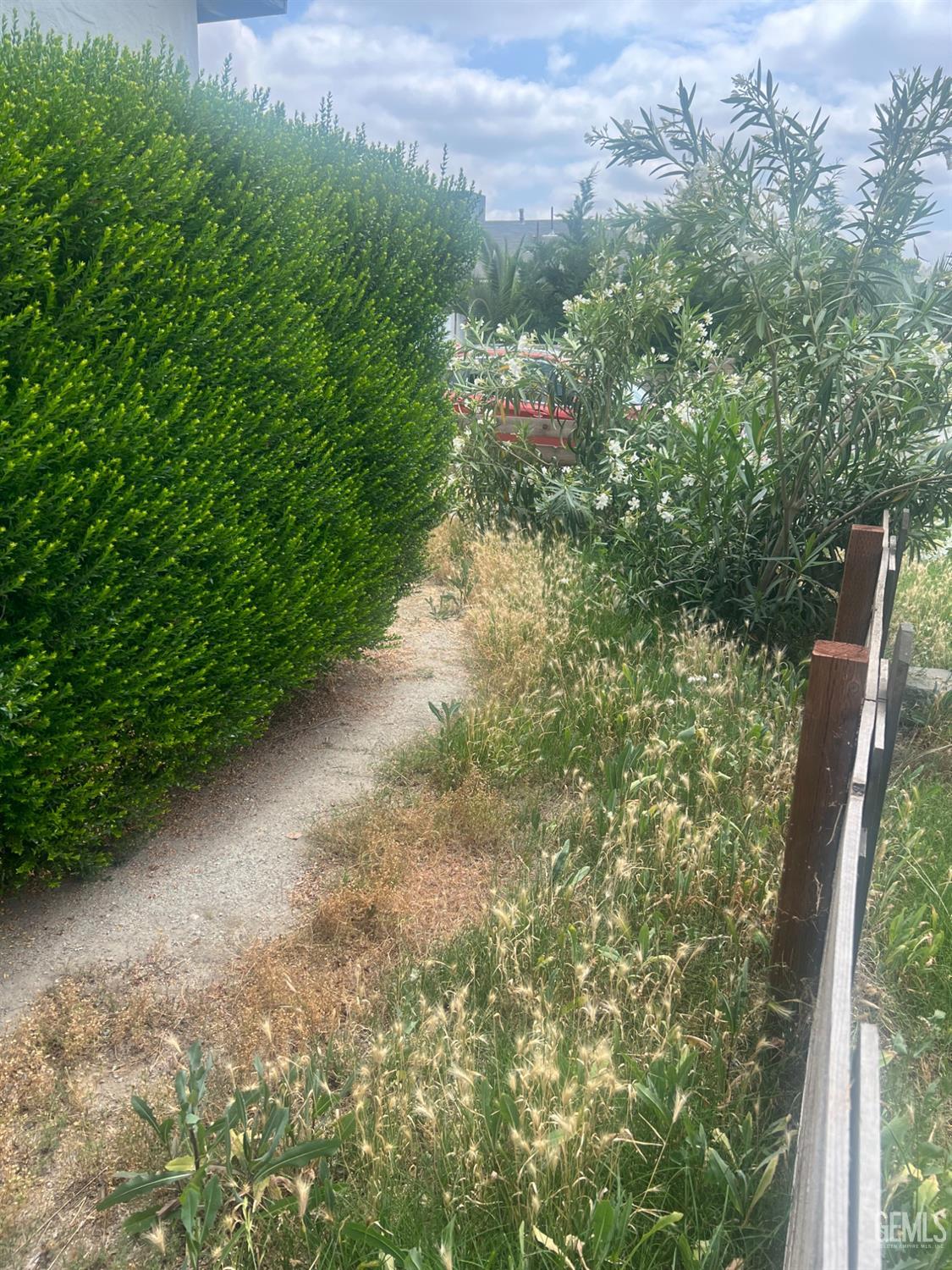Undisclosed Address Visalia, CA 93291 - Photo 14 of 33 a view of a yard with plants and large trees