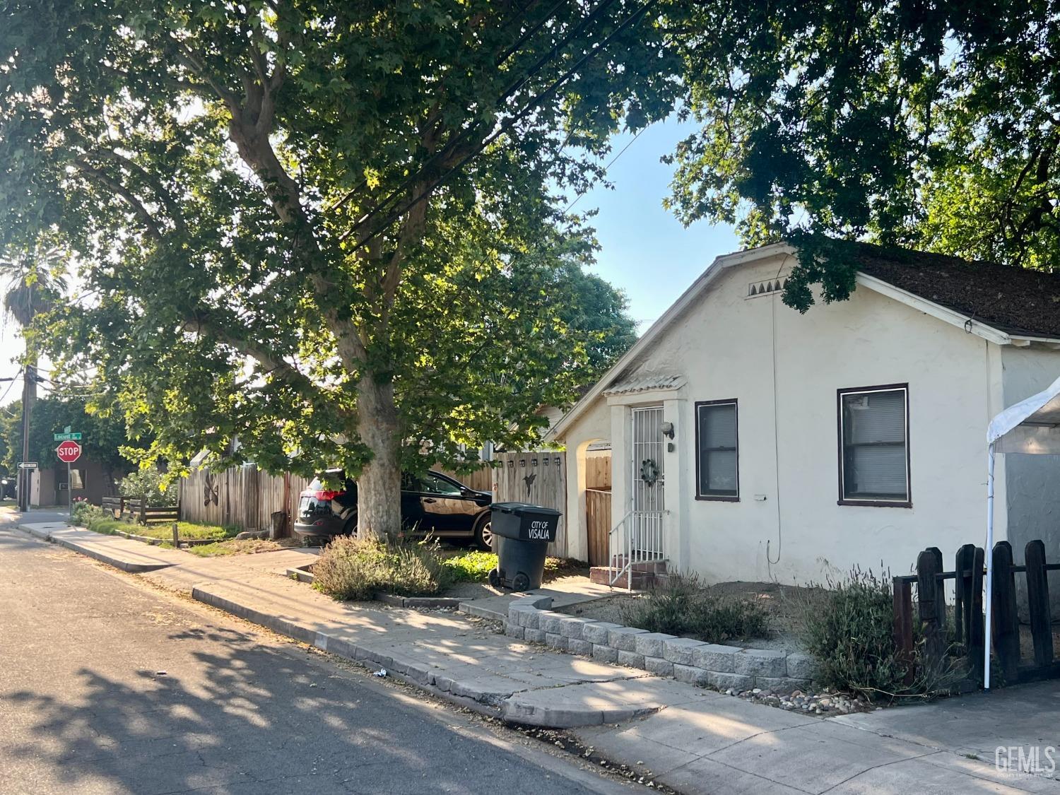 Undisclosed Address Visalia, CA 93291 - Photo 18 of 33 a view of a house with a tree and plants