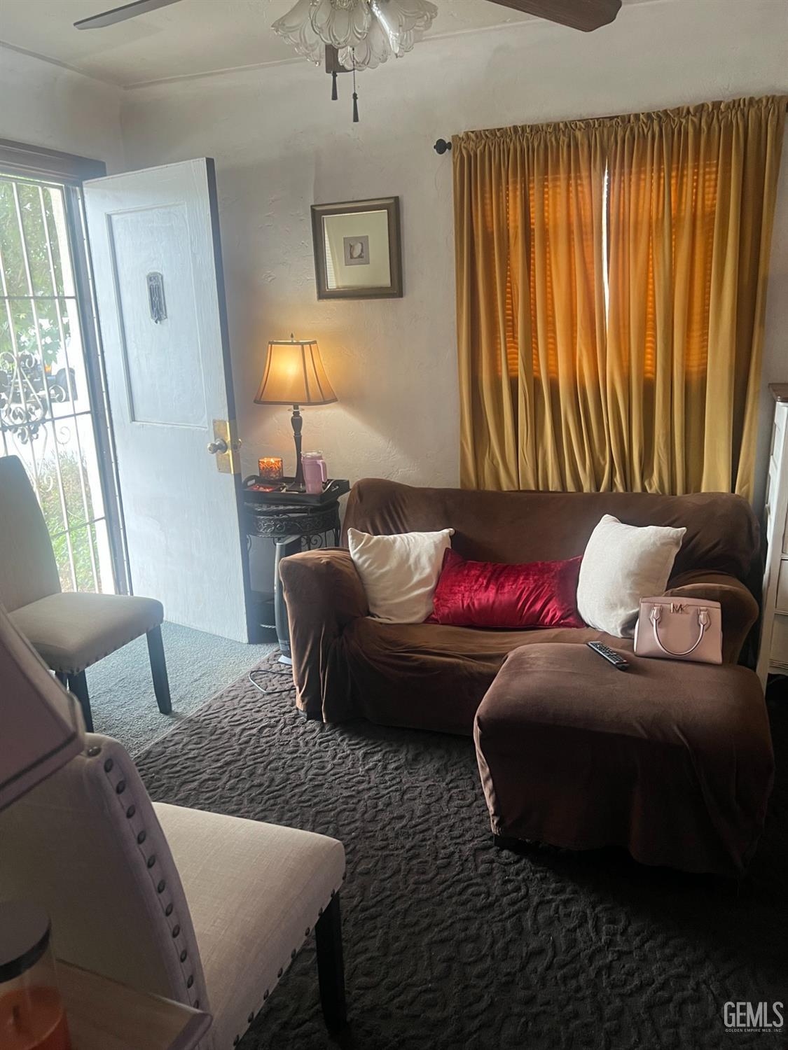 Undisclosed Address Visalia, CA 93291 - Photo 21 of 33 a living room with furniture and a lamp