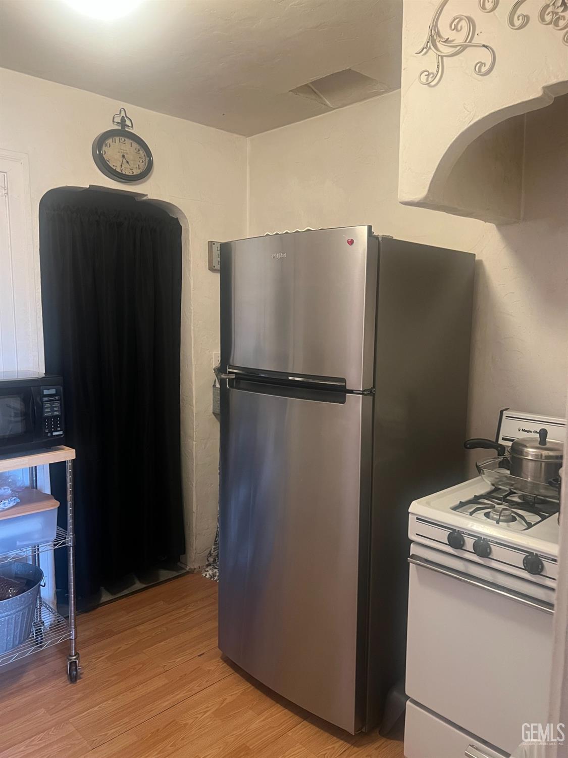 Undisclosed Address Visalia, CA 93291 - Photo 25 of 33 a view of a refrigerator in kitchen and an empty room