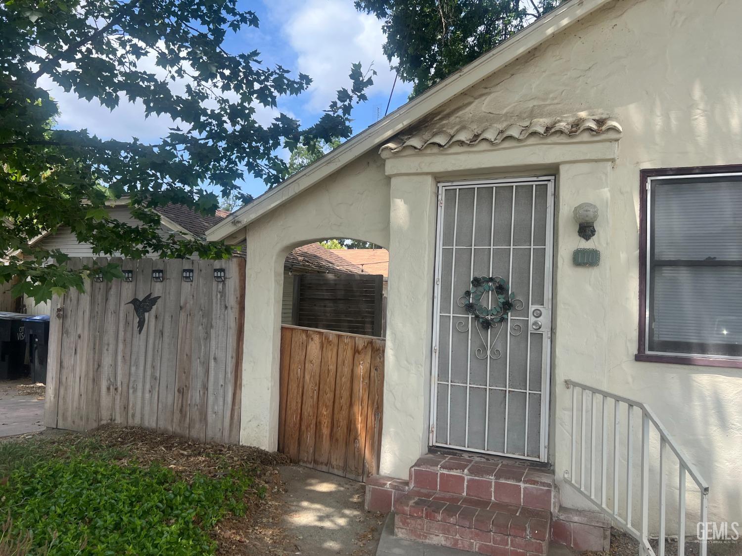 Undisclosed Address Visalia, CA 93291 - Photo 31 of 33 a view of a house with a small yard and wooden fence