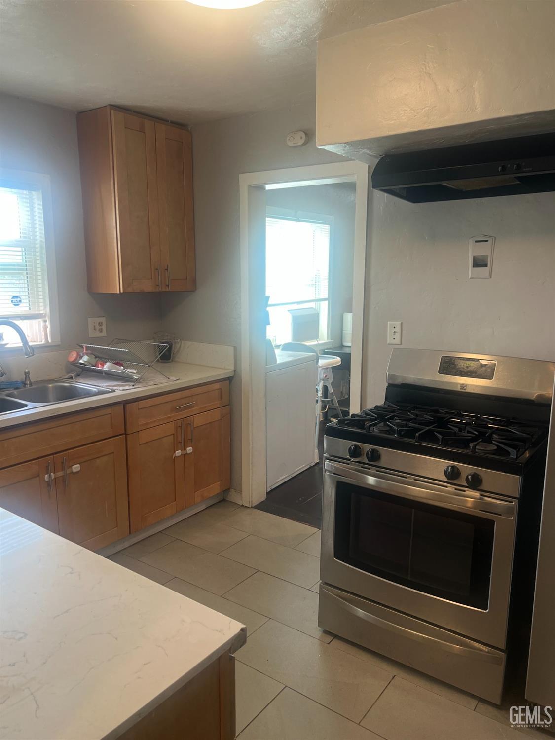 Undisclosed Address Visalia, CA 93291 - Photo 7 of 33 a kitchen with a stove and a sink