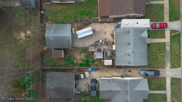 an aerial view of a house with outdoor space