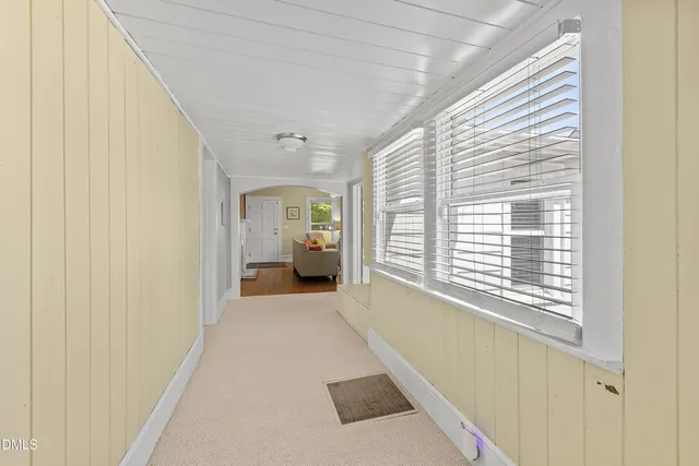 a view of a livingroom with wooden floor and a window