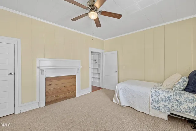 a bedroom with a bed and a fireplace