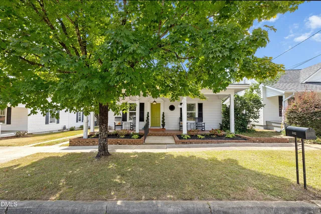 a view of a house with outdoor space and sitting area