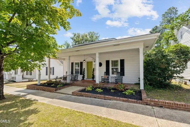 a view of a patio with table and chairs and potted plants