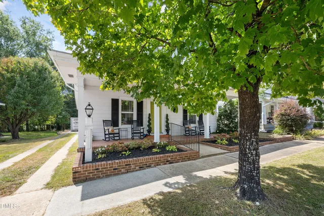 a front view of a house with yard fire pit and tree s