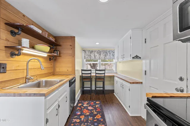 a kitchen with sink cabinets and stainless steel appliances
