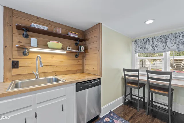 a kitchen with a sink cabinets and appliances