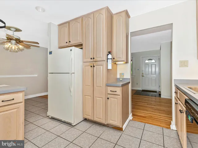 a kitchen with granite countertop cabinets a sink a window and stainless steel appliances