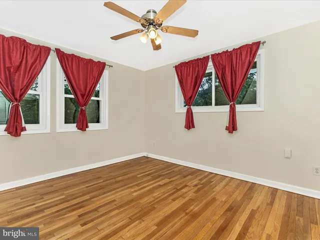 a view of a room with wooden floor and window