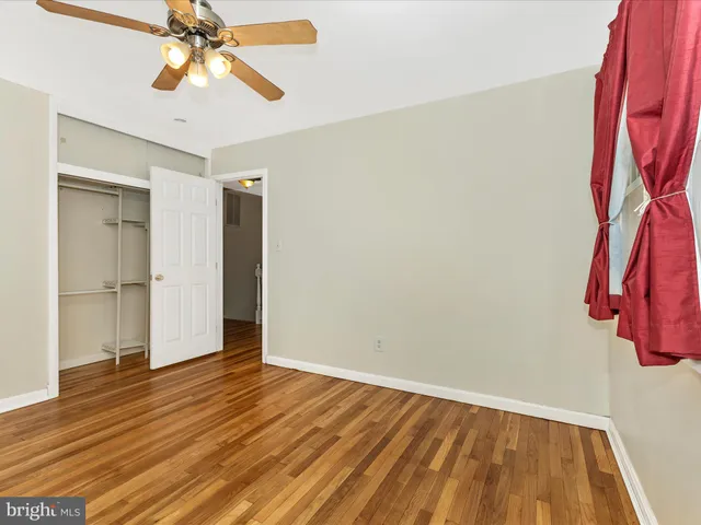 a view of a room with wooden floor and closet