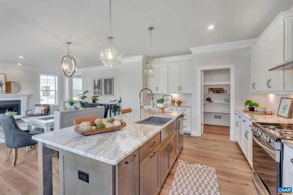 a kitchen with a sink stove and cabinets