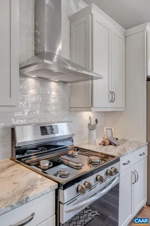 a stove top oven sitting inside of a kitchen