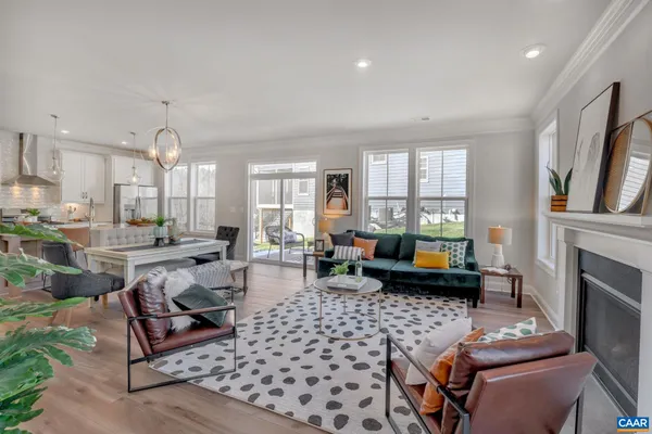 a living room with furniture a fireplace and a chandelier
