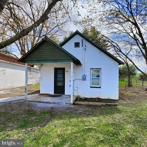 a house that has a tree in front of it