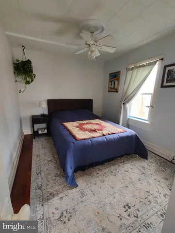 a bedroom with a bed dresser and a window