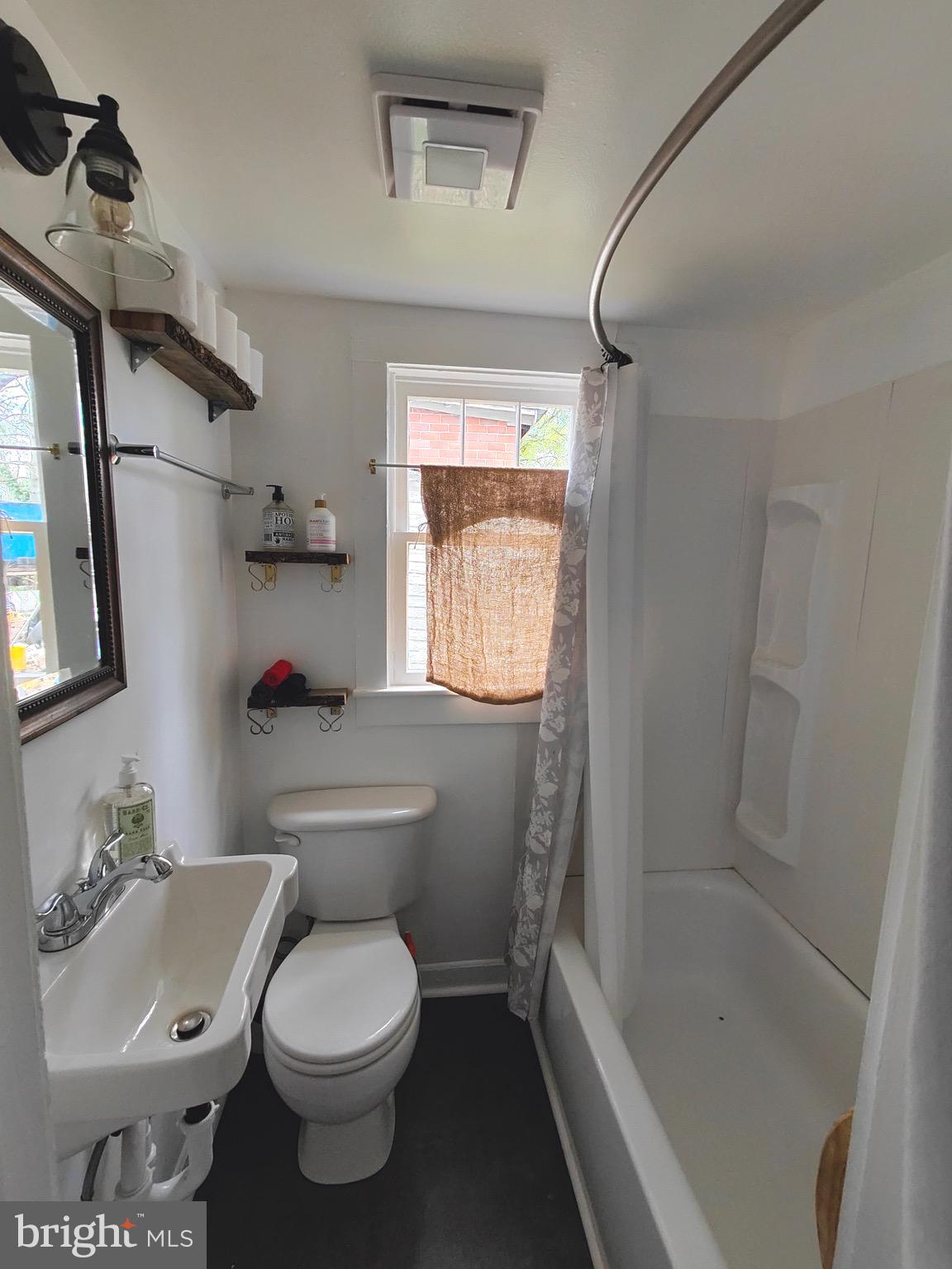 4884 Charles Town Road Kearneysville, WV 25430 - Photo 14 of 22 a white toilet sitting next to a bath tub shower