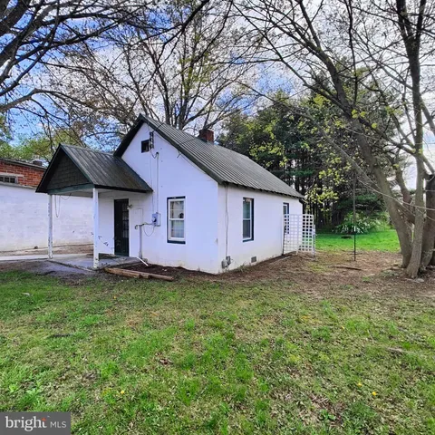 a house that has a tree in front of it