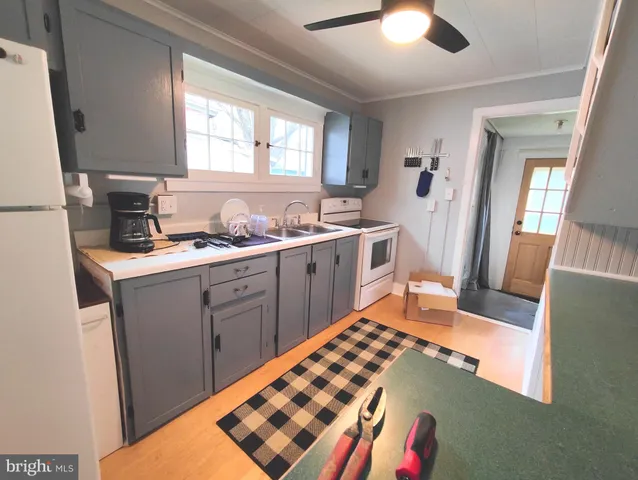 a kitchen with a sink appliances and cabinets