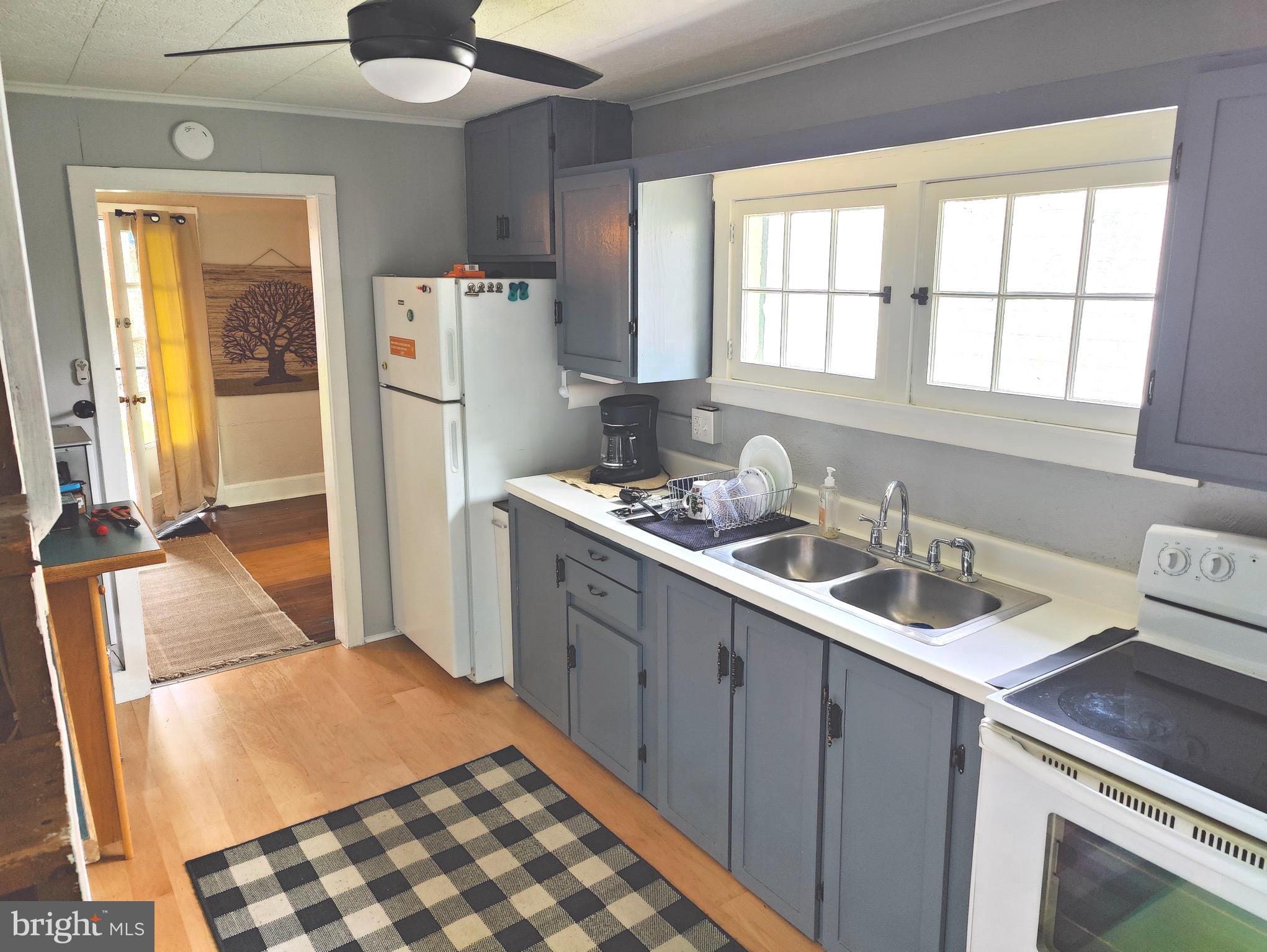 4884 Charles Town Road Kearneysville, WV 25430 - Photo 4 of 22 a kitchen with a sink stove and refrigerator