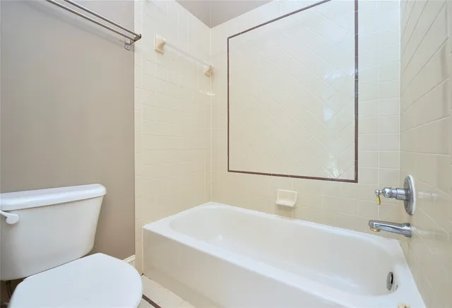 a white bath tub sitting next to a white toilet