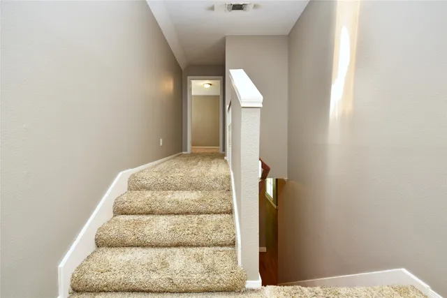 a view of staircase with white walls