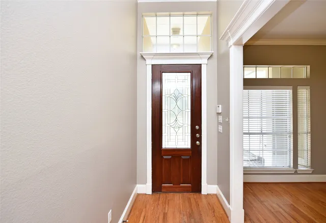 a view of front door with wooden floor