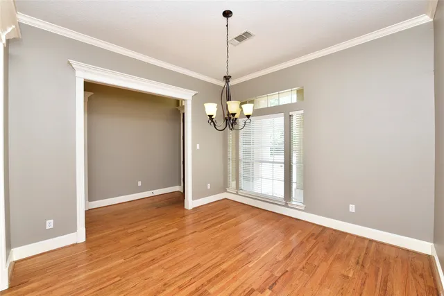 a view of a room with wooden floor wooden floor and windows
