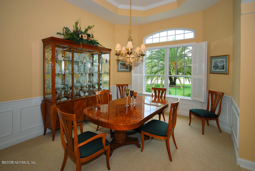 801 Riley Lane St. Augustine, FL 32095 - Photo 4 of 25 a dining room with furniture a chandelier and wooden floor