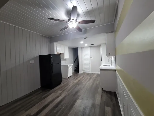 a view of kitchen with refrigerator and window