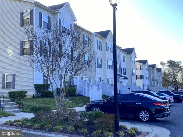 a view of a car in front of a brick house