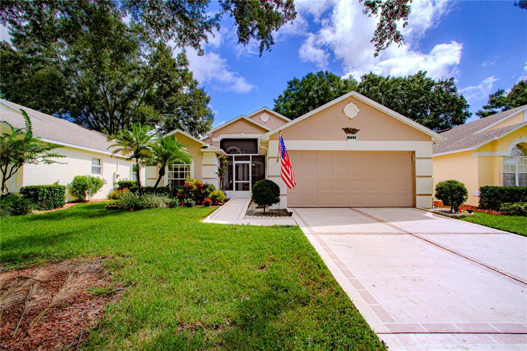 a front view of a house with a yard and garage