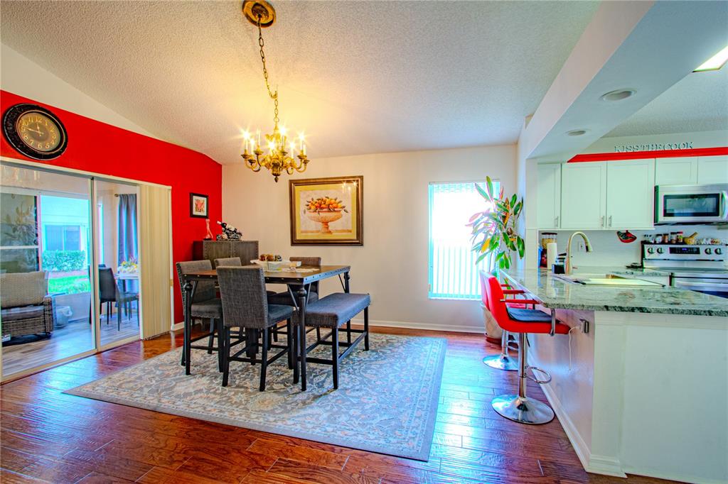 3713 Doune Way Clermont, FL 34711 - Photo 11 of 27 a view of a dining room with furniture and wooden floor
