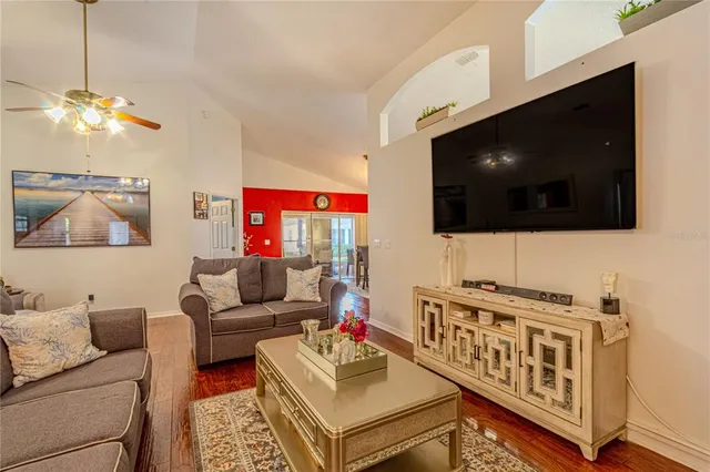a living room with furniture and a flat screen tv
