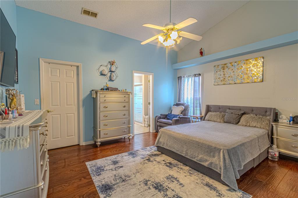 3713 Doune Way Clermont, FL 34711 - Photo 15 of 27 a bedroom with a bed and wooden floor