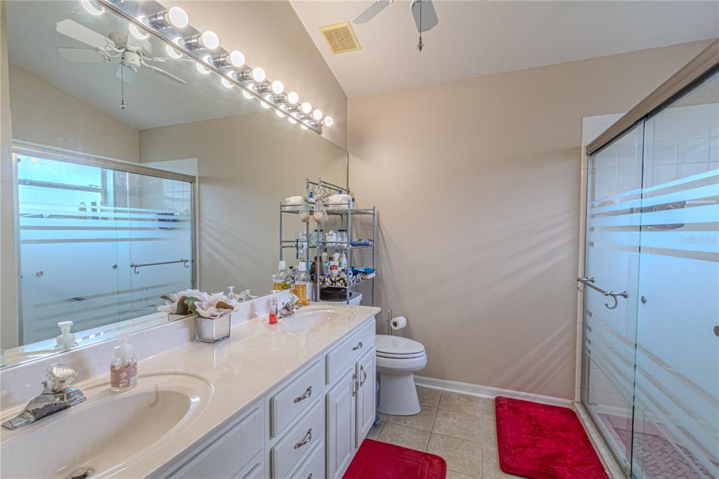 3713 Doune Way Clermont, FL 34711 - Photo 17 of 27 a bathroom with a sink vanity granite and toilet