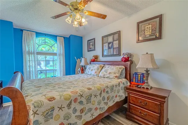 a bedroom with a bed and a chandelier