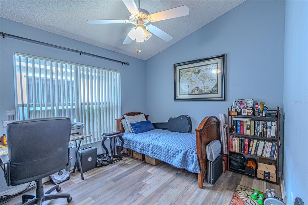 3713 Doune Way Clermont, FL 34711 - Photo 22 of 27 a bedroom with furniture and a book shelf