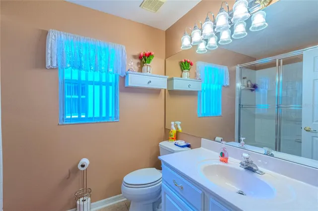 a bathroom with a sink a toilet and a mirror