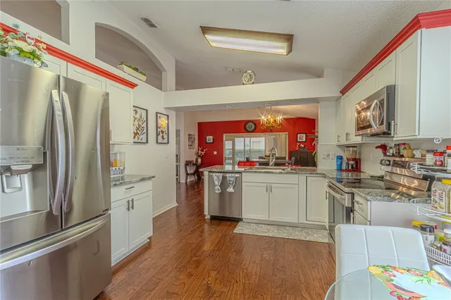 a kitchen with stainless steel appliances granite countertop a refrigerator and stove