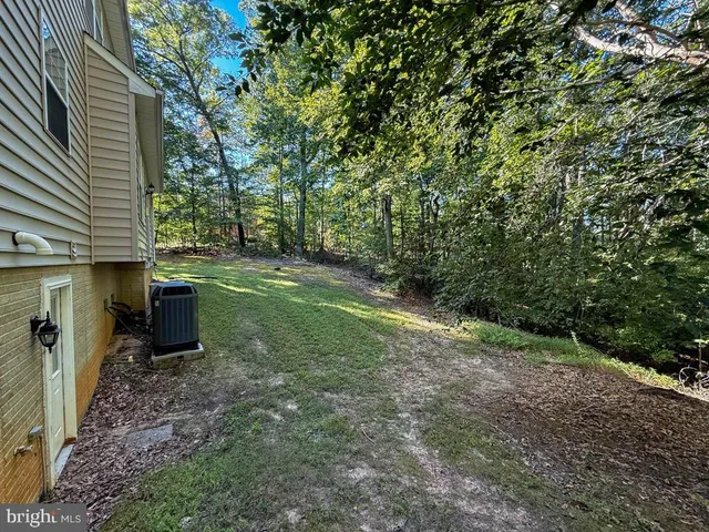 a view of a field with trees in the background