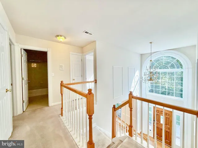 a view of an entryway with wooden floor and windows