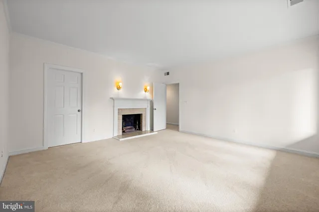 a view of an empty room with a fireplace