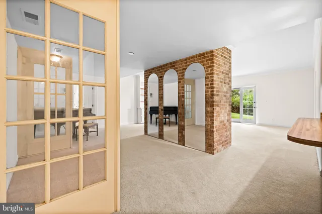 a view of a livingroom with furniture and floor to ceiling window