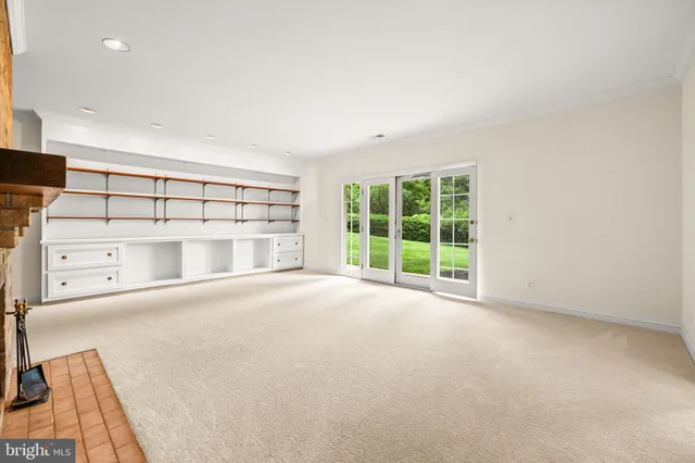 en empty room with a fireplace and a large window