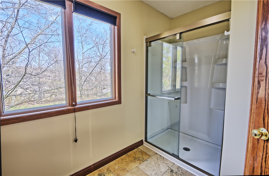 8711 Nicole Lane Springboro, OH 45066 - Photo 46 of 87 Bright, inviting bathroom featuring a sleek shower enclosure and large windows with serene views.