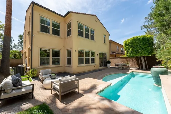 a view of a patio with couches and a table and chairs with garden view